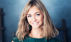 Woman smiling after dental checkup and teeth cleaning in Metairie