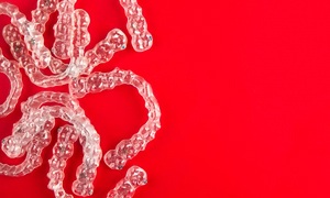 Multiple clear aligners on a red background