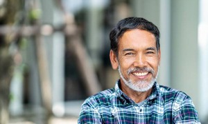 Older man in plaid shirt smiling