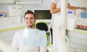 Younger man smiling in dentist’s chair