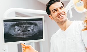 Dentist showing a patient a set of dental x rays