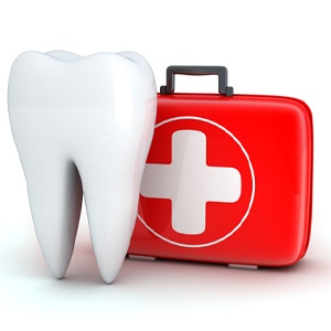 Model of a tooth next to a first-aid kit