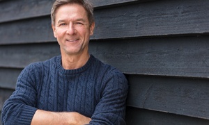 Smiling man wearing a blue sweater