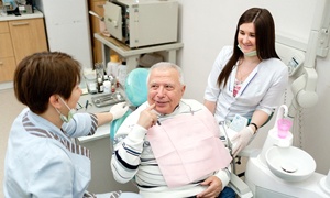 Senior patient and dentist discussing candidacy for implant dentures
