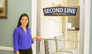 Dentist in front of entrance to Second Line Family dentistry