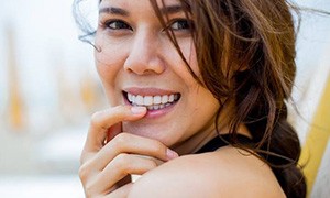 Woman smiling with hand on chin