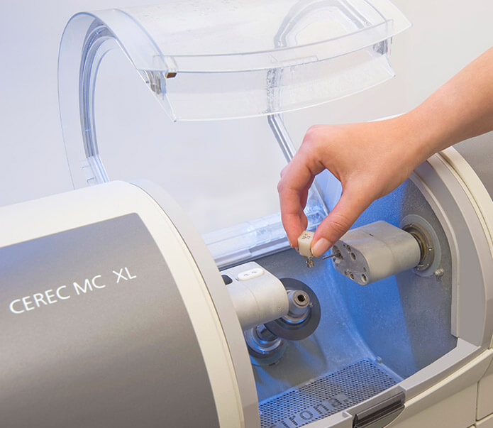 Person creating a dental crown with milling machine