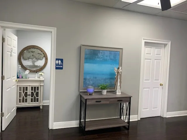 Small desk and restroom in dental office