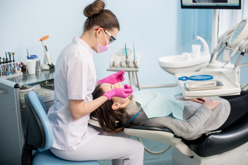 A dental hygienist performing a teeth cleaning for a patient