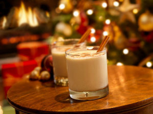 Two glasses of eggnog on a wooden table